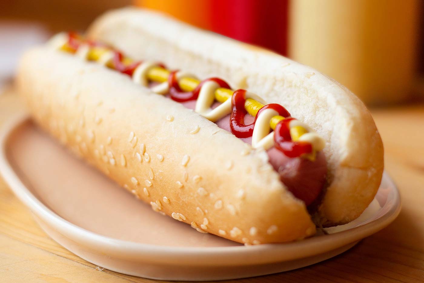 Single basic hot dog on plate, by Jessica Loaiza via Unsplash